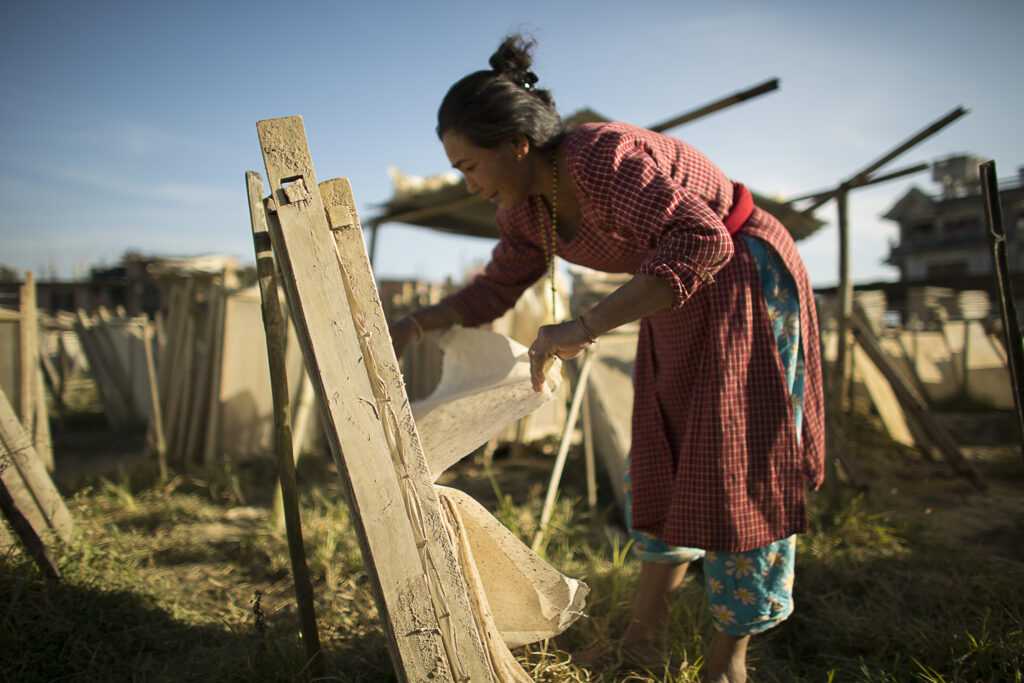 Woman working with wood to create sustainable luxury products.