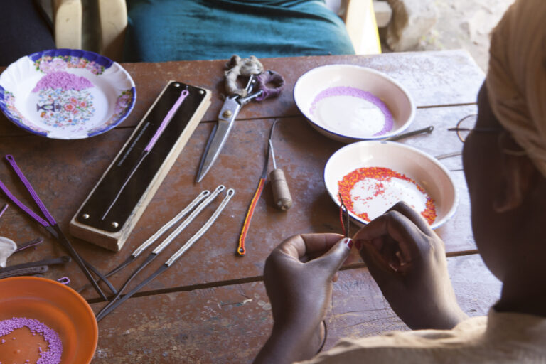 A women's group in the Nairobi slum of Korogocho works on Chan Luu bracelets for Ethical Fashion.