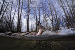 Patagonia Ambassador Dylan Tomine fishing in the woods.