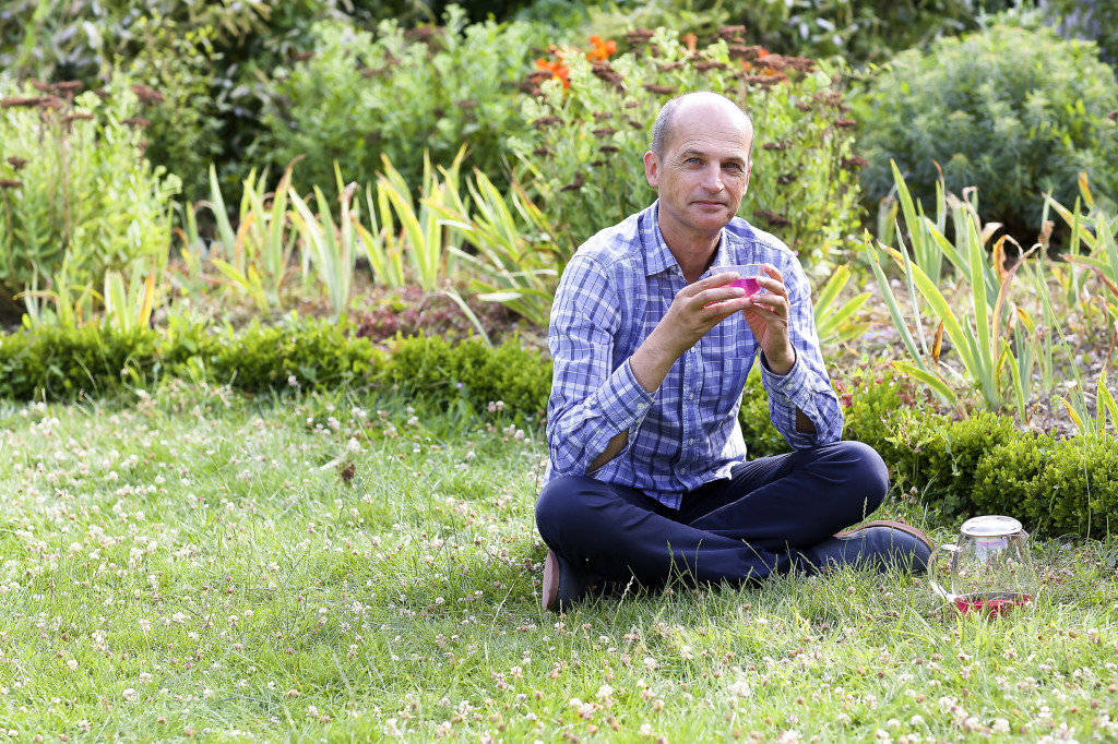 Portrait of François-Xavier Delmas, founder of organic tea company, Palais des Thés, in his own garden in 1991.