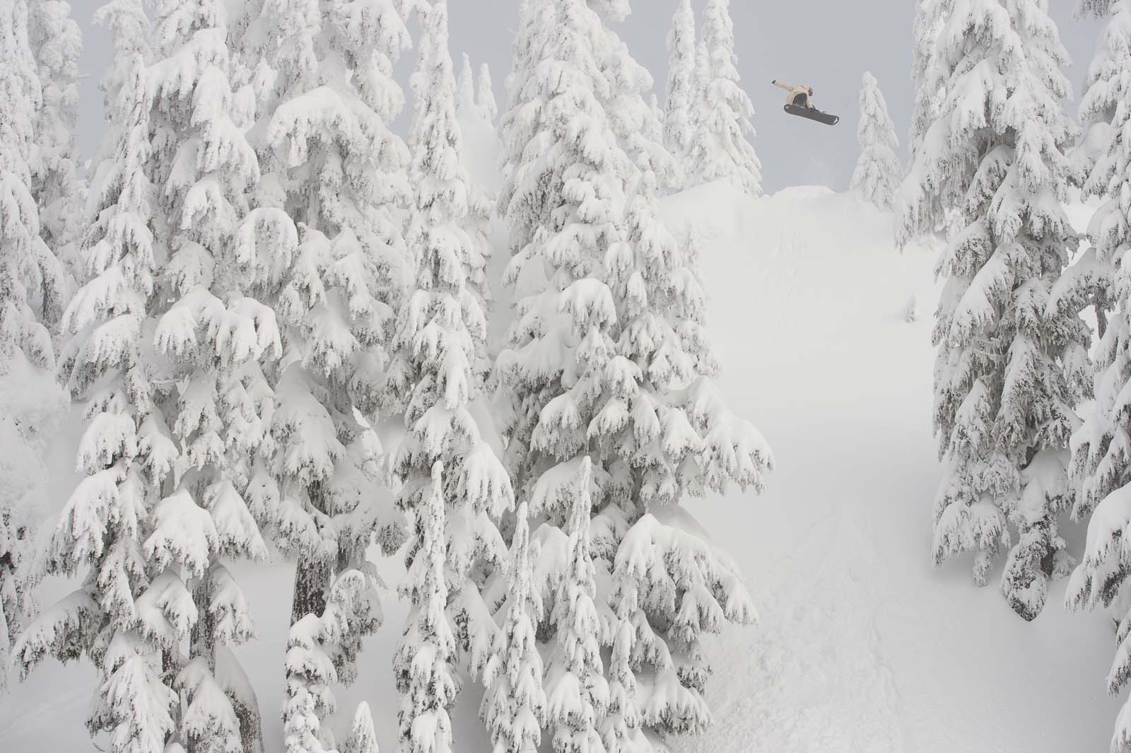 Mark Sollors, professional Burton snowboarder, jumping off snowy mountain.