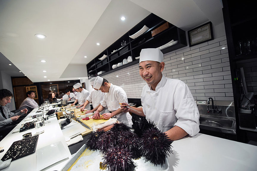 Chefs making food at Sushi Nakazawa, a restaurant that sources fresh fish.