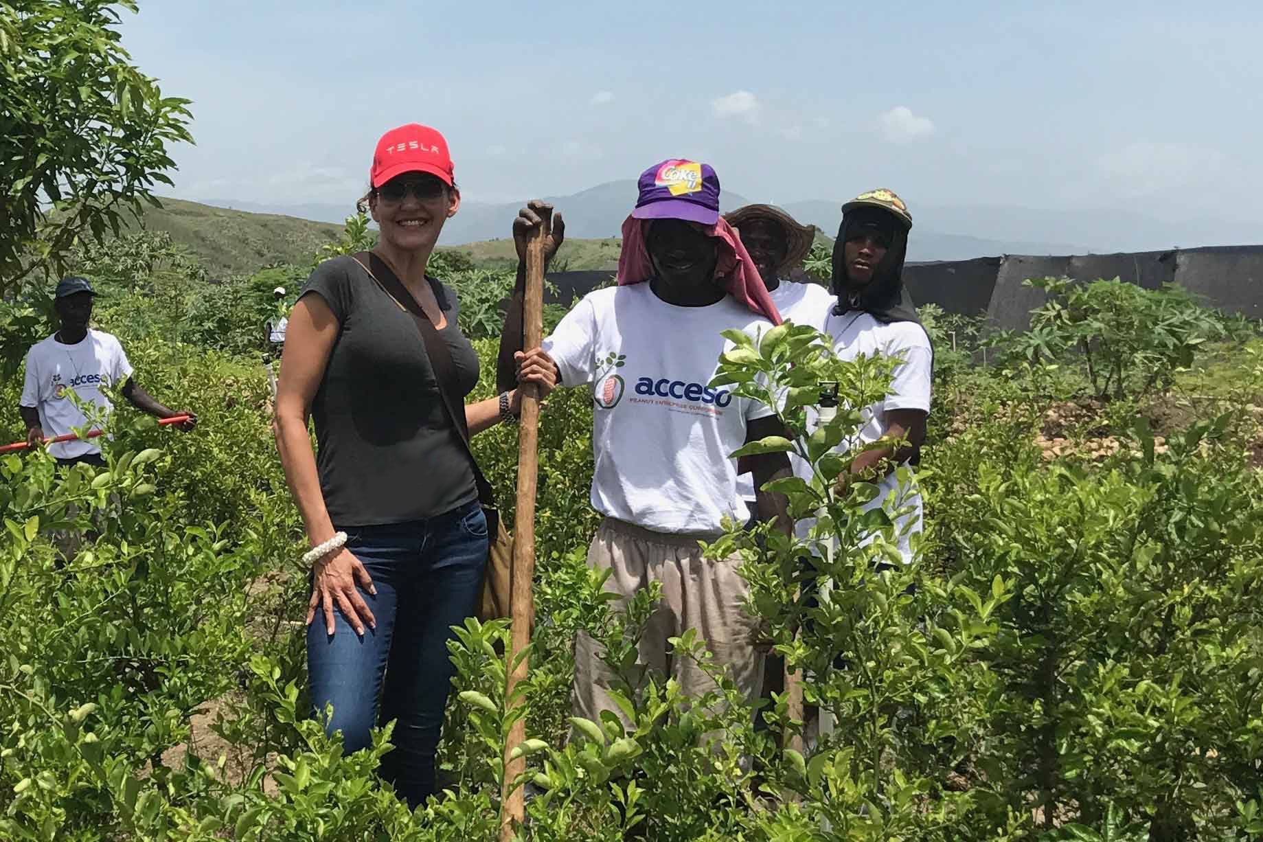 Workers of 7 Virtues, a clean fragrance brand, in a grassland in Haiti.