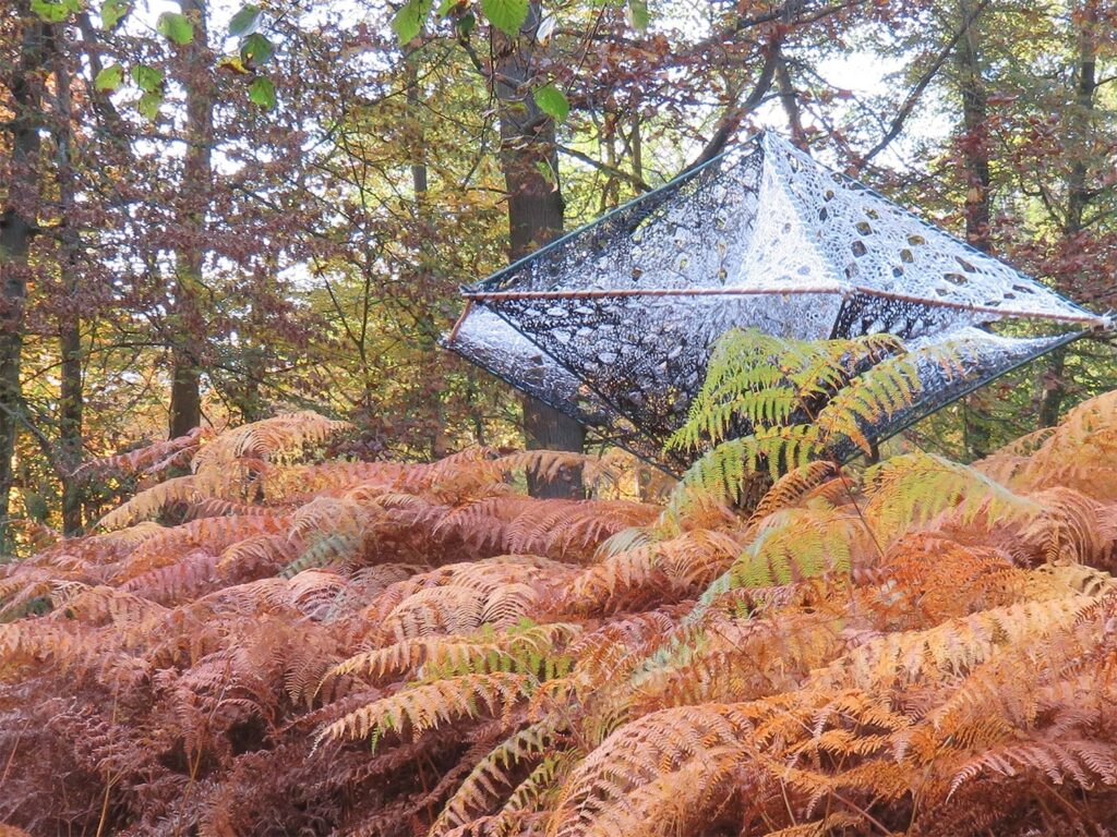 Meusnier, french artist, fiber sculpture surrounded by trees.