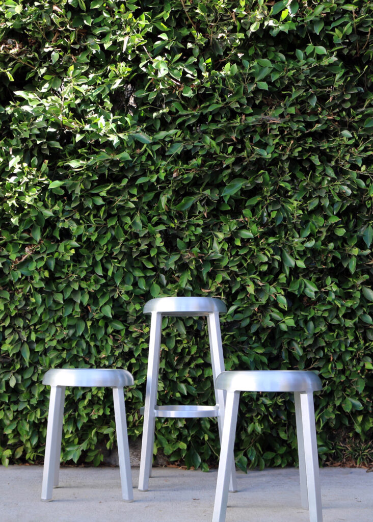 Handmade Emeco chairs outside.