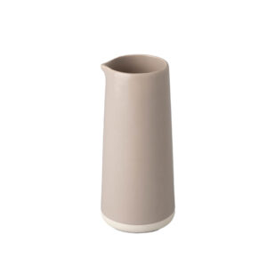 Tall cylindrical pitcher, with a taupe body and cream colored bottom.